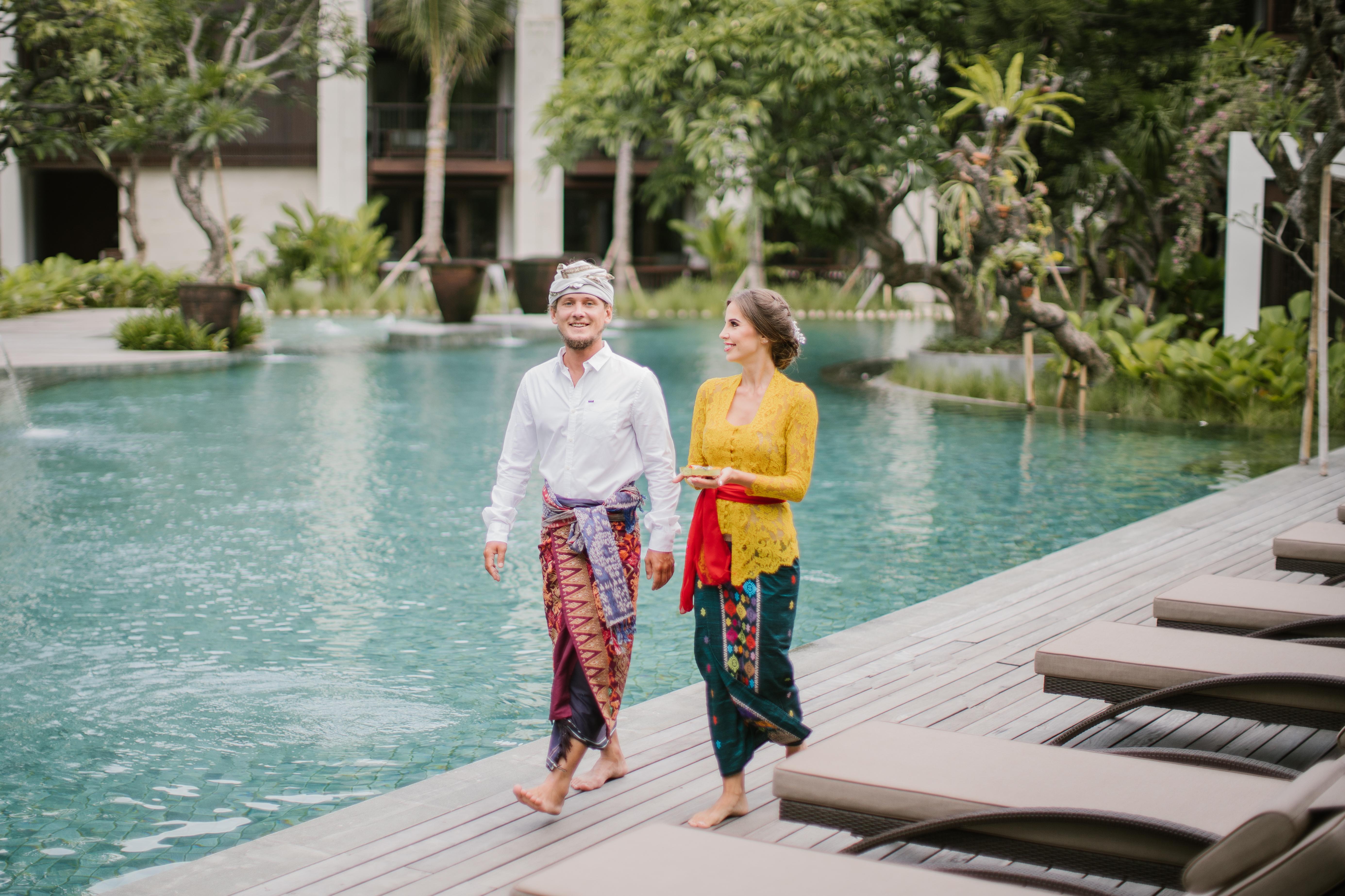 Ramayana Suites And Resort Кута Экстерьер фото A Balinese couple wearing traditional Balinese attire